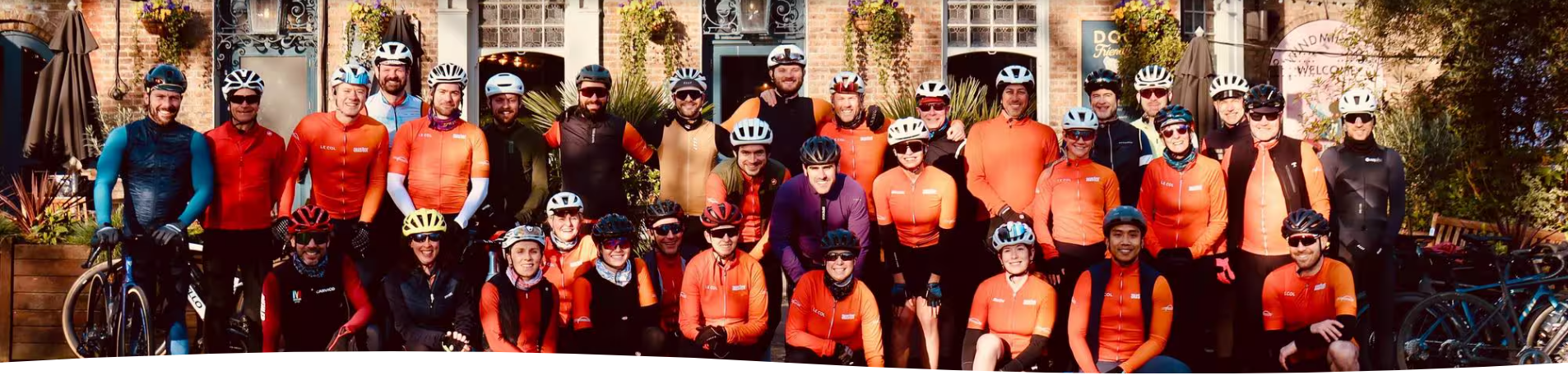 Auster Cycling Club — group ride in orange jerseys